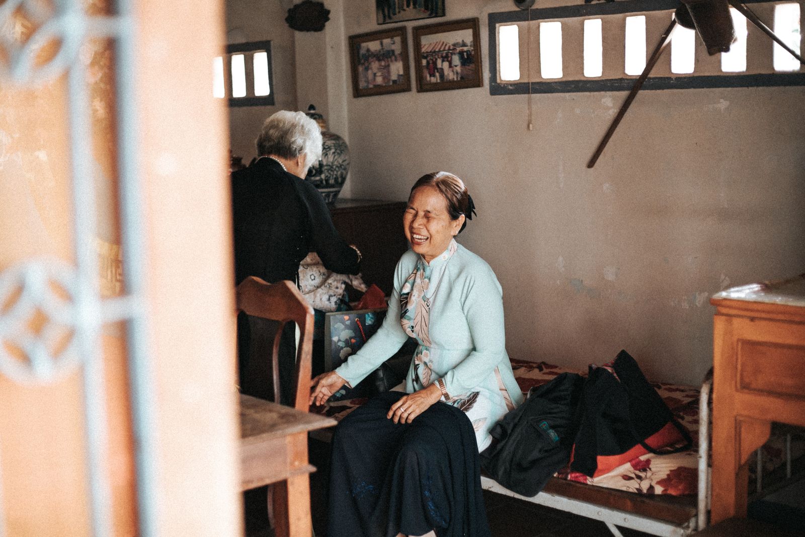 A thoughtful woman in a warm, lived-in home